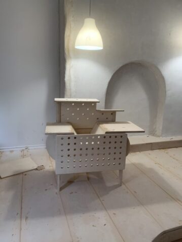 Is it a kitchen or a workshop table? Open ended play with peg holes and spinning doors.